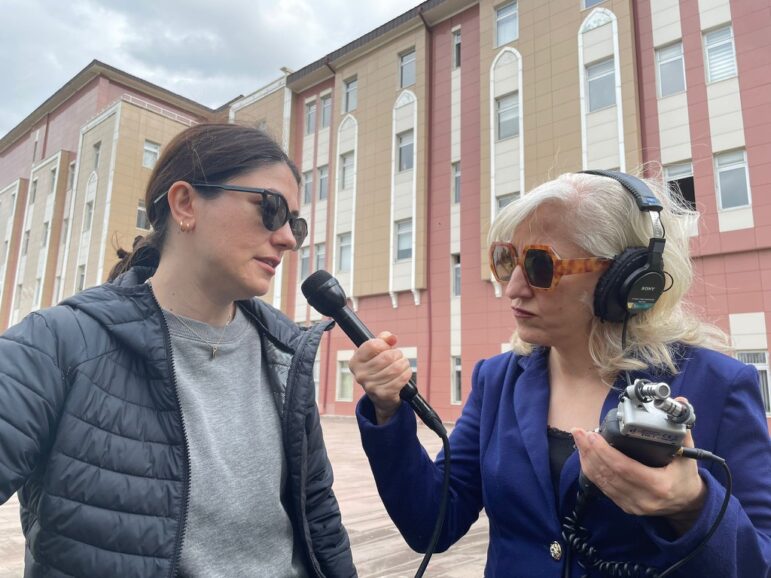 On Spec podcast host Fariba Nawa (right) interviewing the team's reporter, Beril Eski, outside a courthouse in Balikesir, Turkey